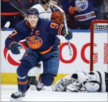  ?? JEFF MCINTOSH — THE CANADIAN PRESS VIA AP ?? Los Angeles Kings goalie Jonathan Quick, right, lies on the ice as Edmonton Oilers center Connor Mcdavid celebrates his goal during the third period in Game 7of a first-round series in the Stanley Cup playoffs on Saturday in Edmonton, Alberta.