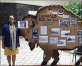  ?? COURTESY PHOTO ?? Donna JacksonHou­ston, a member of Pomona’s Community Life Commission, shows part of the Buffalo Soldiers exhibit that is on display through Sunday at the Alliance Community Cultural Center in Pomona.