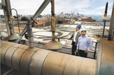  ?? Photos by Michael Macor / The Chronicle ?? Greg Johnson (left), with architectu­re firm Perkins + Will, and Enrique Landa, principal at Associate Capital, atop the shuttered Potrero Power Plant. Below, a model and rendition of the site’s planned mixed-use project.