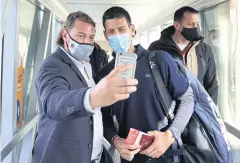  ?? REUTERS ?? A man takes a selfie with Novak Djokovic as the tennis star arrives at Nikola Tesla Airport in Belgrade yesterday.