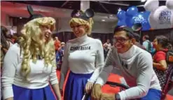  ??  ?? Mouseketee­rs Alana Villemez, left, Kelsey Schwarz, center, and Ian Ruz share a laugh during the D23 Expo.