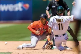  ?? AP Photo/John Hefti ?? Oakland Athletics’ Skye Bolt (11) seals second base in front of Houston Astros shortstop Jeremy Pena during the fifth inning Sunday in Oakland, Calif.