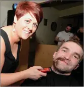  ??  ?? Catriona Cullinane taking the razor to Darren Murphy at the Shave or Dye fundraiser