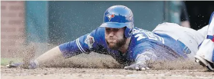  ?? TONY GUTIERREZ/THE ASSOCIATED PRESS ?? Blue Jays catcher Russell Martin scores against the Texas Rangers during the seventh inning in Game 4 of ALDS on Monday in Arlington, Texas.