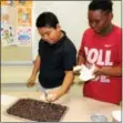  ?? DIGITAL FIRST MEDIA FILE PHOTO ?? Students made a healthy snack out of celery and raisins during a family Wellness Night at Barth Elementary School in Pottstown.