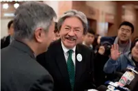  ?? AFP ?? John Tsang, Hong Kong’s former financial secretary, (centre) at a news conference after submitting his nomination form for the chief executive election in Hong Kong. —