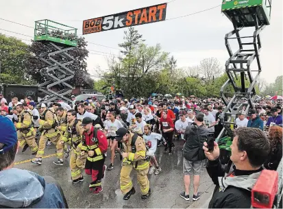  ?? BILL SAWCHUK TORSTAR FILE PHOTO ?? Runners, including St. Catharines firefighte­rs in full gear and full tanks, leave the starting line at the 2019 Rankin Cancer Run in St. Catharines. After cancelling the 2020 event, organizers announced the fundraiser will not be held in 2021 either.