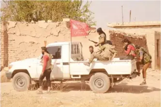  ??  ?? RAEL, Syria: Syrian rebel fighters get into a pickup truck flying an Islamist flag in this northern village after they captured it from the Islamic State group in the Marj Dabiq area north of the embattled city of Aleppo yesterday. — AFP