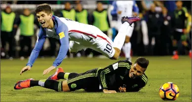  ?? ADAM CAIRNS/TRIBUNE NEWS SERVICE ?? Mexico defender Carlos Salcido (3) trips United States midfielder Christian Pulisic (10) in a World Cup qualifying match in Columbus, Ohio, on Nov. 11, 2016. Mexico won, 2-1, although Salcido received a yellow card for the play.