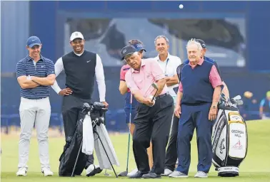  ?? Photo / AP ?? Lee Trevino chips onto the green at St. Andrews watched by, from left, Rory Mcilroy, Tiger Woods and Jack Nicklaus.