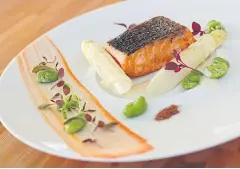  ??  ?? Pan-fried and smoked wild keta salmon with French white asparagus and fava beans.