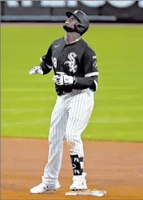  ?? JOHN J. KIM/CHICAGO TRIBUNE ?? Rookies who made big league debuts without family present include Royals pitcher Brady Singer, above, against the Indians on Saturday and the White Sox’s Luis Robert, left, on Friday.