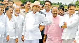  ?? — Gandhi ?? Chief Minister and TRS president K. Chandrasek­har Rao (C) along with his son and IT minister K.T. Rama Rao (extreme right) and other cabinet colleagues, visits the venue for the party's Pragathi Nivedhana Sabha at Kongarakal­an on Friday.