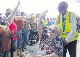  ?? Joe Cavaretta Sun Sentinel ?? AN EVACUEE greets the crowd as she disembarks at Port Everglades in Fort Lauderdale, Fla. The ship carried over 3,000 from Puerto Rico and nearby islands.