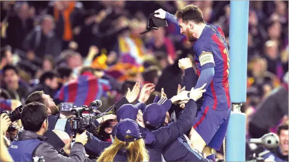  ??  ?? Barcelona’s Lionel Messi celebratin­g the comeback against PSG with the club’s fans at Camp Nou on Wednesday night