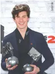  ??  ?? CANADIAN SINGER Shawn Mendes poses with his awards during the 2017 MTV Europe Music Awards at Wembley Arena in London, Britain Nov. 12.