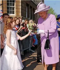  ?? ?? Casey Williams presenting a posy to Her Majesty the Queen outside Shire Hall