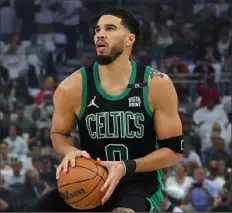  ?? Stacy Revere/Getty Images ?? Boston Celtics forward Jayson Tatum, who had 30 points, takes a 3-point shot against the Milwaukee Bucks Monday.