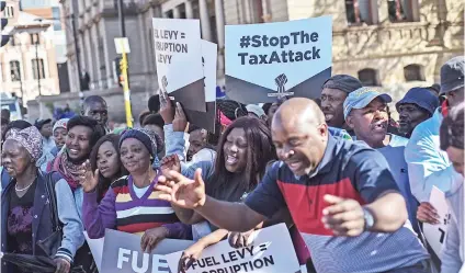  ?? Picture: Jacques Nelles ?? ALL FIRED UP. Members from different political parties gathered outside the National Treasury’s offices in Pretoria yesterday to demand a reduction in the fuel levy.