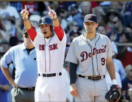  ?? ELISE AMENDOLA — THE ASSOCIATED PRESS ?? Boston Red Sox’s Mookie Betts celebrates his RBI triple as Detroit Tigers third baseman Nick Castellano­s watches in the eighth inning at Fenway Park Wednesday in Boston. The Tigers won 4-3.