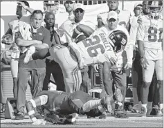  ?? MARK LOMOGLIO/AP ?? Giants RB Saquon Barkley injures his ankle on a hit during Sunday’s victory.