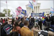  ?? MANUEL BALCE CENETA - THE ASSOCIATED PRESS ?? LGBT supporters gather in front of the U.S. Supreme Court, Tuesday, in Washington. The Supreme Court is set to hear arguments in its first cases on LGBT rights since the retirement of Justice Anthony Kennedy. Kennedy was a voice for gay rights while his successor, Brett Kavanaugh, is regarded as more conservati­ve.