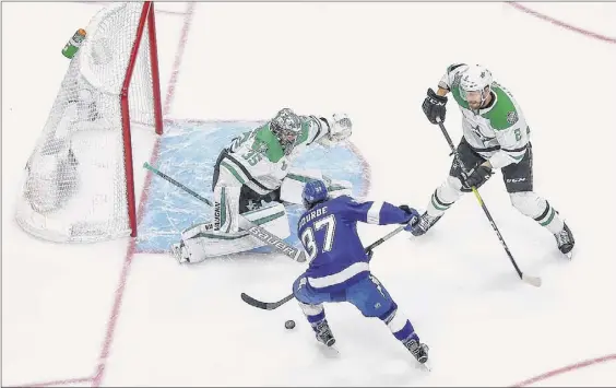  ?? Bruce Bennett / Getty Images ?? Dallas’ Anton Khudobin makes a save against Tampa Bay’s Yanni Gourde. Game 5 didn’t end in time for this edition. Go to: http://timesunion.com.