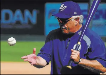  ?? JEFF SINER/THE CHARLOTTE OBSERVER FILE ?? Las Vegas 51s manager Wally Backman hits grounders to infielders during pregame warmups for the Triple-A All-Star Game at BB&amp;T Ballpark in Charlotte, N.C., on July 13. Backman left the New York Mets organizati­on on Tuesday.
