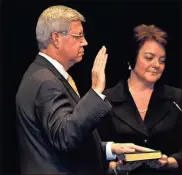  ??  ?? State Court Solicitor General Doug Woodruff takes his oath of office.