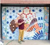  ?? PROVIDED PHOTO ?? David Najib Kasir as he worked on his Uptown mural last August.