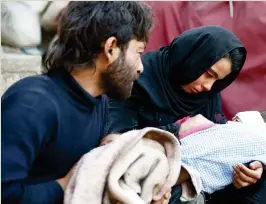  ??  ?? Heba Amouri holds the body of her two-year-old son, Emir Al-Bash, at a medical center in the besieged town of Douma, Eastern Ghouta, Syria. (Reuters)