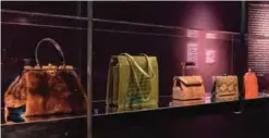  ??  ?? This undated photo provided by the Museum of Arts and Design shows a display case which includes a mink satchel and a green alligator bag, both from 1988. — AP photos