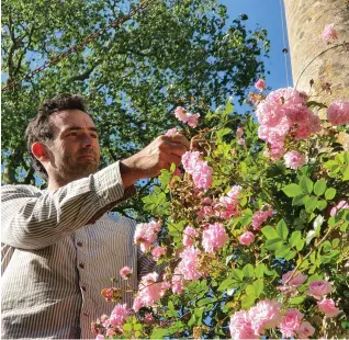  ??  ?? Pictured previous spread: View from the loggia window. Inspired by this glorious 15th century Venetian window ,the loggia was one of the first things that Peto built when he moved to Iford. Above left-right: Troy Scott Smith expertly prunes and ties in historic roses; the newly restored cloister originally built by Harold Peto.