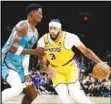  ?? Associated Press ?? The Lakers’ Anthony Davis (3) tries to get around the Phoenix Suns’ Deandre Ayton during the first half on Tuesday in Phoenix. The Lakers lost to the Suns 115-105.