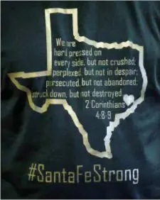  ?? DAVID J. PHILLIP — THE ASSOCIATED PRESS ?? Dayspring Church senior pastor Brad Drake wears a shirt in support of the school shooting victims Sunday in Santa Fe, Texas. Congregati­ons in this deeply religious community near Houston gathered Sunday for their first worship services since a teenager...