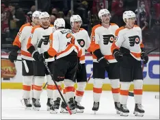  ?? PATRICK SEMANSKY — THE ASSOCIATED PRESS ?? The Flyers celebrate after beating the Capitals on Saturday in Washington. Philadelph­ia won 2-1.