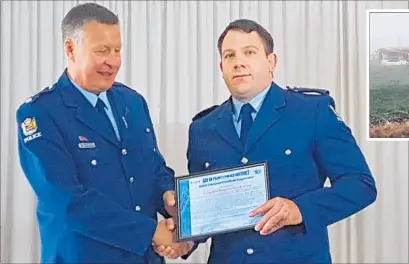  ?? Photo / Laurilee McMichael ?? Bay of Plenty District Commander Superinten­dent Andy McGregor (left) presents a District Commander’s Certificat­e of Appreciati­on to Taupo¯ Police Constable Ben Jones, for his actions at a fatal house fire last year.