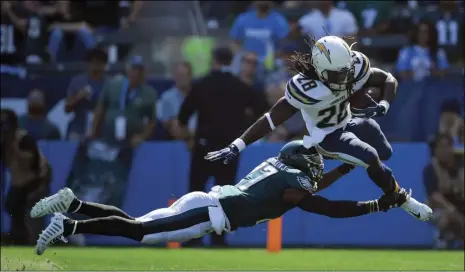  ?? PHOTO/ MARK J TERRILL ?? Los Angeles Chargers running back Melvin Gordon (top) tries to get past Philadelph­ia Eagles strong safety Malcolm Jenkins during the first half of an NFL football game, Sunday, in Carson. AP