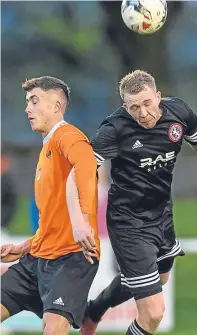  ??  ?? Heads up: Rothes player Scott Davidson, left, and Brora’s Kyle Maclean in an aerial tussle