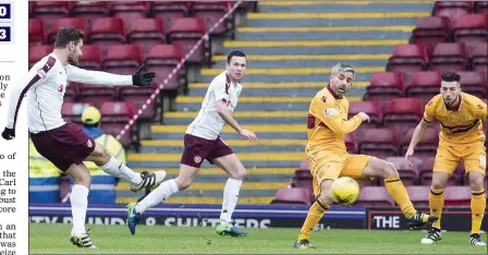  ??  ?? DEBUT GOAL: Tziolis sees his strike loop up off the outstretch­ed foot of Keith Lasley on its way into the Motherwell net