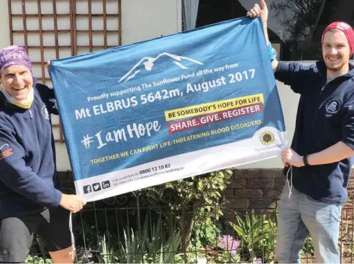  ??  ?? UNFLAGGING: Cancer survivor and tireless campaigner Ray Funnell and his son Jay hold a Sunflower Fund banner, which they intend to raise at the summit of Mount Elbrus in Russia this week to promote awareness about cancer and stem cell donation.