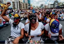  ?? — AFP ?? Venezuelan Opposition activists take part in a march aimed to keep pressure on President Nicolas Maduro, whose authority is being increasing­ly challenged by protests and deadly unrest in Caracas