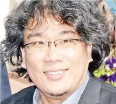  ??  ?? Director Bong Joon-ho, who premiered ‘Okja’ at the 2017 Cannes Film Festival where it competed for the Palme d’Or, has joined the production of the American TV series ‘Snowpierce­r’ as executive producer.