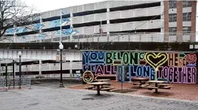  ?? ?? A public area of Quackenbus­h Square in downtown Albany, on the south side of the new Common Roots Brewing Co. Albany Outpost, has a view of two murals created as part of the Capital Walls project. They decorate but do not disguise a parking garage and I-787 exit ramp.