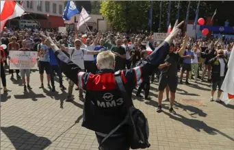  ?? Sergei Grits/Associated Press ?? Workers with old Belarus national flags gather during a rally at the Minsk Motor Plant in Minsk, Belarus, on Monday.