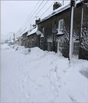  ?? Pic: Ray Hayes ?? Snow packed up against houses in Wexford’s Faythe in March.