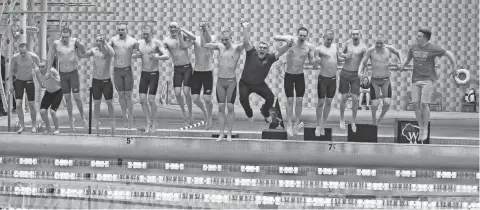  ?? / FOR THE MILWAUKEE JOURNAL SENTINEL ?? Waukesha South/Catholic Memorial’s swim team along with coach Blaine Carlson jump in the UW Natatorium pool after winning the D1 state title Saturday.