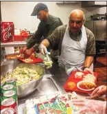  ?? OULA MIQBEL/ NEWS-SENTINEL ?? Ehtesham Qamar adds a portion of salad to a tray before adding a slice of cake. The Lodi Muslim community hosts a meal service on the first Sunday of every month at the Salvation Army on North Sacramento Street.
