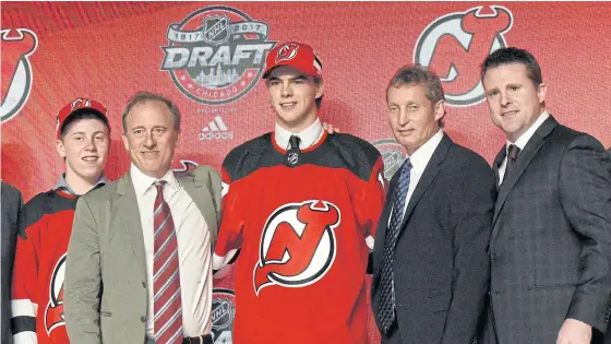  ??  ?? Nico Hischier poses for photos after being selected as the No.1 overall pick by the New Jersey Devils.