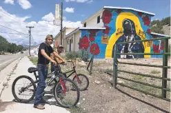  ?? DANIEL J. CHACÓN/THE NEW MEXICAN ?? Ojo Caliente residents Dillan Peña, 13, and Mario Campos, 23, say they find the vandalism of the Virgin Mary mural ‘very disrespect­ful’ and that they don’t understand why someone damaged it.